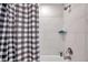 Shower with black and white shower curtain, tile walls and chrome fixtures at 5351 Bridge St # 81, Tampa, FL 33611