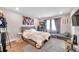Bedroom features light hardwood floors, area rug, overhead lighting, and double bed with storage underneath at 5351 Bridge St # 81, Tampa, FL 33611