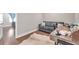 Comfortable bedroom featuring a gray couch, a desk and hardwood floors with neutral paint at 5351 Bridge St # 81, Tampa, FL 33611