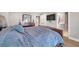 Bright bedroom with a large bed, TV, and view into the bathroom at 5351 Bridge St # 81, Tampa, FL 33611