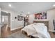 Bedroom featuring wood flooring, overhead lighting and full-sized bed with storage drawers underneath at 5351 Bridge St # 81, Tampa, FL 33611