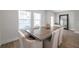 Elegant dining room with wood-look tile, large window and rustic table at 5351 Bridge St # 81, Tampa, FL 33611