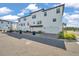 Beautiful exterior view of a three-story townhome featuring a white facade and individual garages at 5351 Bridge St # 81, Tampa, FL 33611