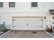 Attached garage features a modern door with black accents and brick paved driveway at 5351 Bridge St # 81, Tampa, FL 33611