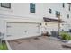 Row of attached garages showcase modern doors and brick paved driveways at 5351 Bridge St # 81, Tampa, FL 33611