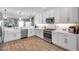 Well-lit kitchen boasts stainless steel appliances, white cabinetry, and a view into the living area at 5351 Bridge St # 81, Tampa, FL 33611