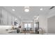 Bright kitchen features white cabinets, stainless steel appliances, and adjacent dining area at 5351 Bridge St # 81, Tampa, FL 33611