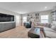 Comfortable living room boasts stylish furniture, decor, and a large TV for entertainment at 5351 Bridge St # 81, Tampa, FL 33611