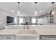 Open living room with a large island and stainless steel farmhouse style sink at 5351 Bridge St # 81, Tampa, FL 33611