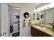 Bathroom with an extended vanity, decor, and a door leading to the bedroom at 612 Allegheny Dr, Sun City Center, FL 33573