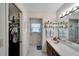 Bathroom with closet, vanity, and window with blue accents at 612 Allegheny Dr, Sun City Center, FL 33573