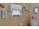 Bathroom with vintage wallpaper and white fixtures at 612 Allegheny Dr, Sun City Center, FL 33573