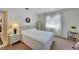 Bedroom with light walls, white linens, decor, and a window provides natural light at 612 Allegheny Dr, Sun City Center, FL 33573