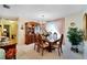 Traditional dining room features chandelier, wood furniture, china cabinet, and views of the backyard at 612 Allegheny Dr, Sun City Center, FL 33573
