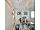 Hallway with white tile flooring, coat closet, mirrors, and front door at 612 Allegheny Dr, Sun City Center, FL 33573