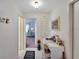 Hallway with white walls and tile, and a built-in desk and storage at 612 Allegheny Dr, Sun City Center, FL 33573