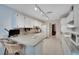 Bright kitchen with white cabinets, countertops, and ample counter space at 612 Allegheny Dr, Sun City Center, FL 33573