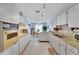 Open kitchen featuring ample cabinetry, countertops, and access to the dining area at 612 Allegheny Dr, Sun City Center, FL 33573