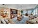 Spacious living room with plush seating, large entertainment center, and ceiling fan at 612 Allegheny Dr, Sun City Center, FL 33573