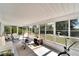 Bright sun room featuring panoramic views of the landscaped garden at 612 Allegheny Dr, Sun City Center, FL 33573