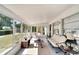 Bright sunroom featuring large windows with views of the landscaped yard and comfortable seating at 612 Allegheny Dr, Sun City Center, FL 33573