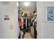 Organized walk-in closet with shelves and hanging clothes, creating ample storage space at 612 Allegheny Dr, Sun City Center, FL 33573