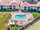 Aerial view of a sparkling community pool overlooking the bay with ample lounge chairs at 6177 Sun Blvd # 401, St Petersburg, FL 33715