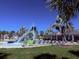 Community pool with a splash pad, lounge chairs and a covered seating area at 6440 Dutton Dr, Wesley Chapel, FL 33545