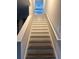 Staircase with painted white trim and wood treads at 6440 Dutton Dr, Wesley Chapel, FL 33545