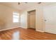 Cozy bedroom with wood floors, closet, and ample natural light from the window at 8401 5Th N St, St Petersburg, FL 33702