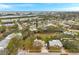 An aerial view of a neighborhood near the waterfront with mature landscaping and single-Gathering homes at 9520 Portside Dr, Seminole, FL 33776