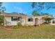 Charming single-story home featuring a landscaped front yard and unique arched entryway at 9520 Portside Dr, Seminole, FL 33776