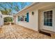 Welcoming front porch featuring a paved floor and a charming arched architectural design at 9520 Portside Dr, Seminole, FL 33776