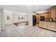 Open concept with tile and wood flooring connecting the living room to the kitchen at 9520 Portside Dr, Seminole, FL 33776