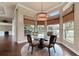 Charming breakfast nook with bay windows offering scenic views of the surrounding greenery and backyard at 5062 Stone Harbor Cir, Wimauma, FL 33598