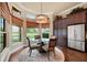 Sun-filled breakfast nook featuring a glass-top table, matching chairs and views of the surrounding landscape at 5062 Stone Harbor Cir, Wimauma, FL 33598