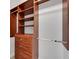 Walk-in closet featuring custom wood shelving and built-in drawers at 5062 Stone Harbor Cir, Wimauma, FL 33598