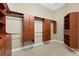 This walk-in closet is fully built-in and has wooden cabinetry at 5062 Stone Harbor Cir, Wimauma, FL 33598