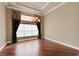 Elegant dining room with hardwood floors, a chandelier, and large windows providing natural light at 5062 Stone Harbor Cir, Wimauma, FL 33598