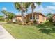 Well-maintained lawn, mature palms and other tasteful landscaping surround this single story house at 5062 Stone Harbor Cir, Wimauma, FL 33598