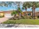 Beautiful single-story home with a well manicured lawn and mature palm trees at 5062 Stone Harbor Cir, Wimauma, FL 33598