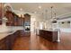 Stylish kitchen featuring stainless steel appliances, custom cabinetry, and a spacious island with a breakfast bar at 5062 Stone Harbor Cir, Wimauma, FL 33598