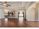 Hardwood flooring flows through the home leading into an open living space with natural light at 5062 Stone Harbor Cir, Wimauma, FL 33598
