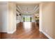 Open living area boasts hardwood floors, a decorative ceiling, with a view to the backyard and dining area at 5062 Stone Harbor Cir, Wimauma, FL 33598