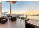 Spacious balcony with contemporary outdoor furniture overlooking bay at 1020 Sunset Point Rd # 703, Clearwater, FL 33755