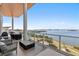 Wide waterfront balcony with plenty of furniture and great views at 1020 Sunset Point Rd # 703, Clearwater, FL 33755