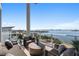 Relax on this spacious balcony with water views and elegant outdoor seating arrangements at 1020 Sunset Point Rd # 703, Clearwater, FL 33755