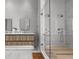 Modern bathroom showcasing a wood vanity, a glass-enclosed shower with dual shower heads, and tile flooring at 1020 Sunset Point Rd # 703, Clearwater, FL 33755