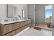 Modern bathroom with double vanity, walk-in shower, and hardwood floors at 1020 Sunset Point Rd # 703, Clearwater, FL 33755