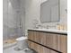 Modern bathroom featuring wood vanity, marble countertop, and a glass-enclosed shower with modern fixtures at 1020 Sunset Point Rd # 703, Clearwater, FL 33755